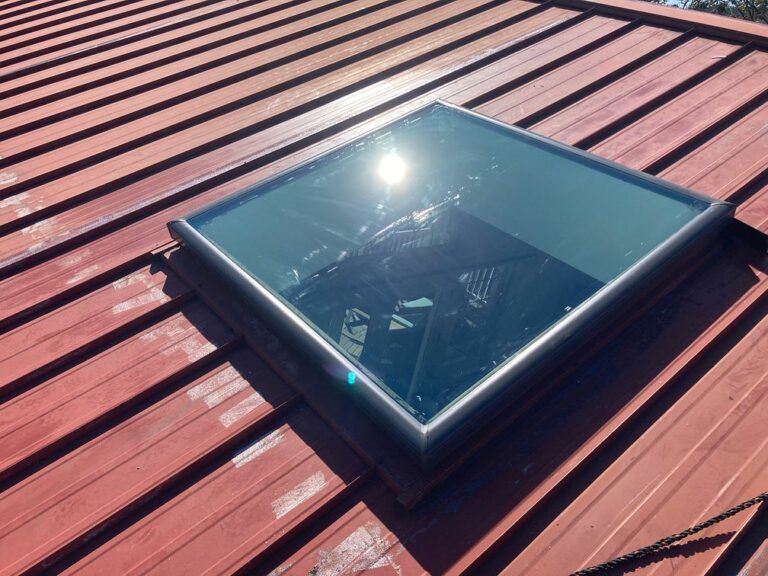 A residential roof with new skylight installation